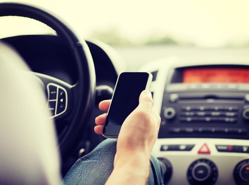 driver with phone in hand